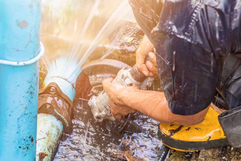 plumber working repair the broken pipe and replace   in hole with water Motion at roadside