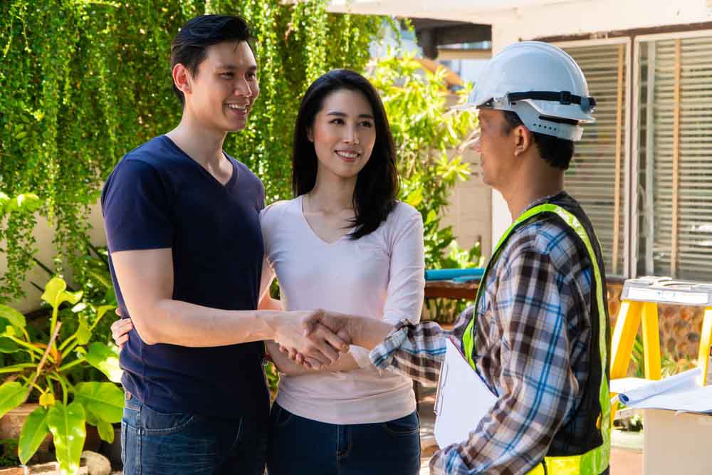 Happy homeowner stand in front of contractor and shake hand, handyman holding clipboard and after checking details before renovations home, house improvement interior, Interior design