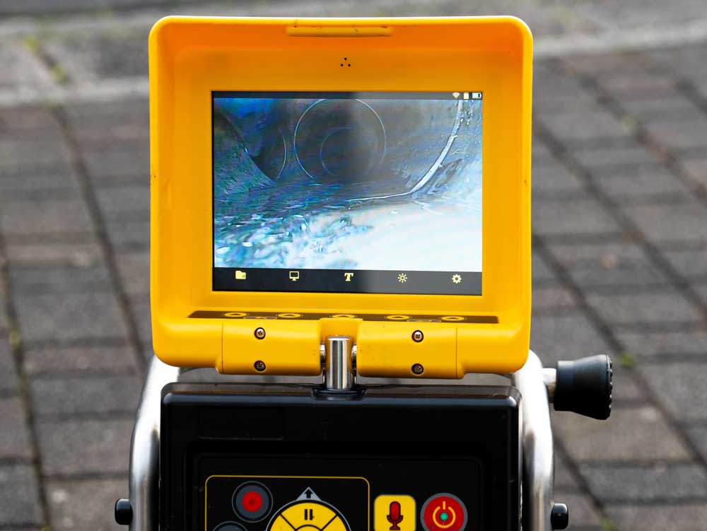technician looking at sewer camera inspection footage